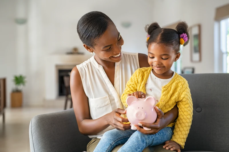mom and daughter saving money